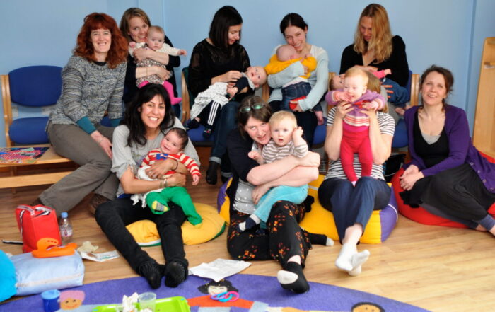 A group of mothers with their babies during a mothers uncovered session.